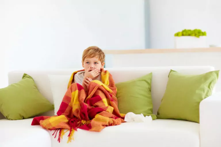 sick kid with runny nose and fever heat at home