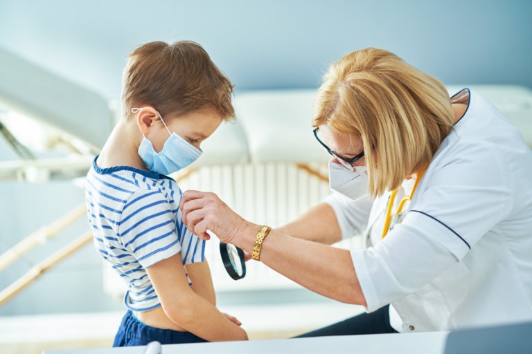 Pediatrician doctor examining little kids in clinic. High quality photo